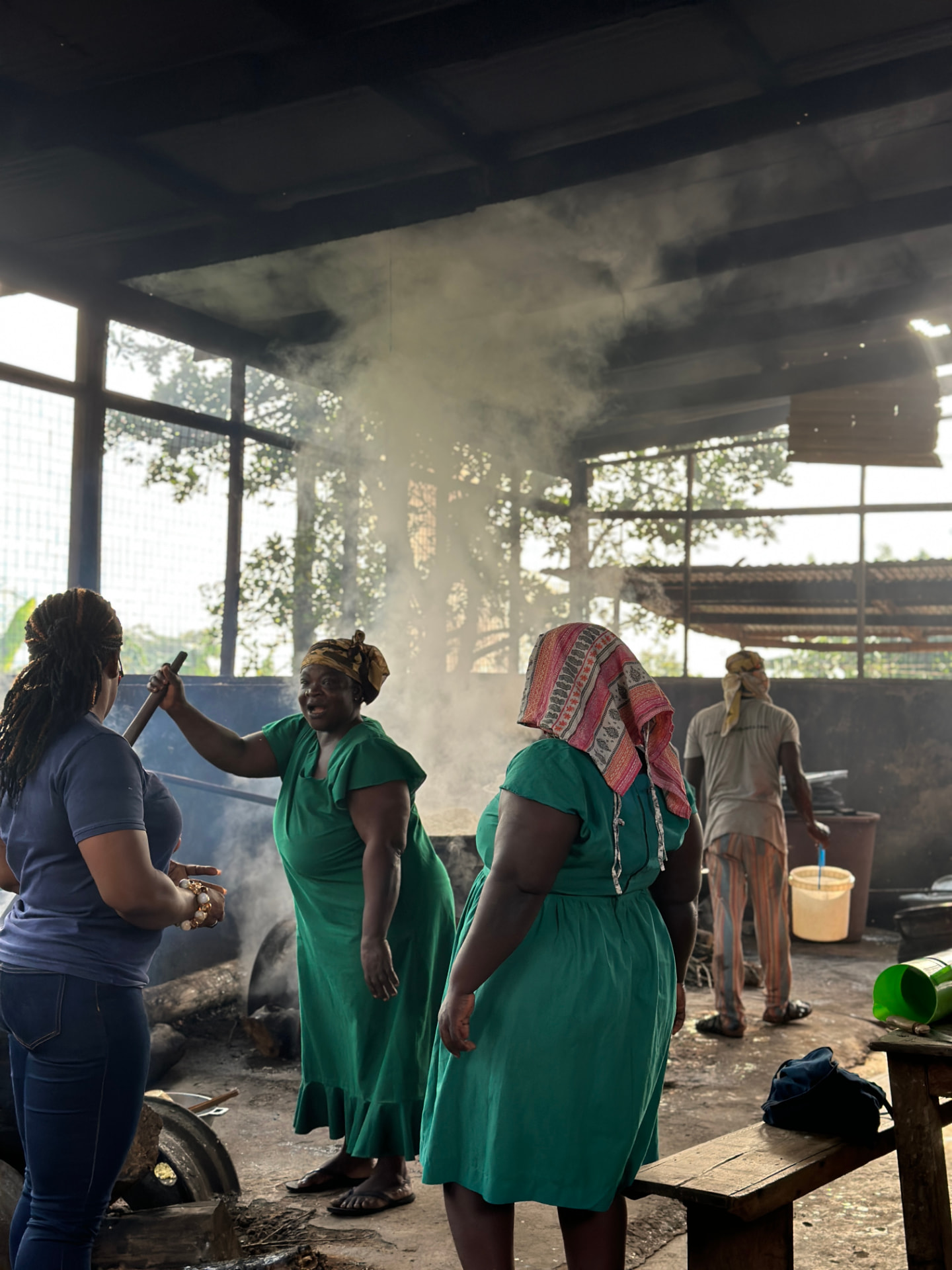 School catering staff in the existing kitchen with smoke rising from the cooking area